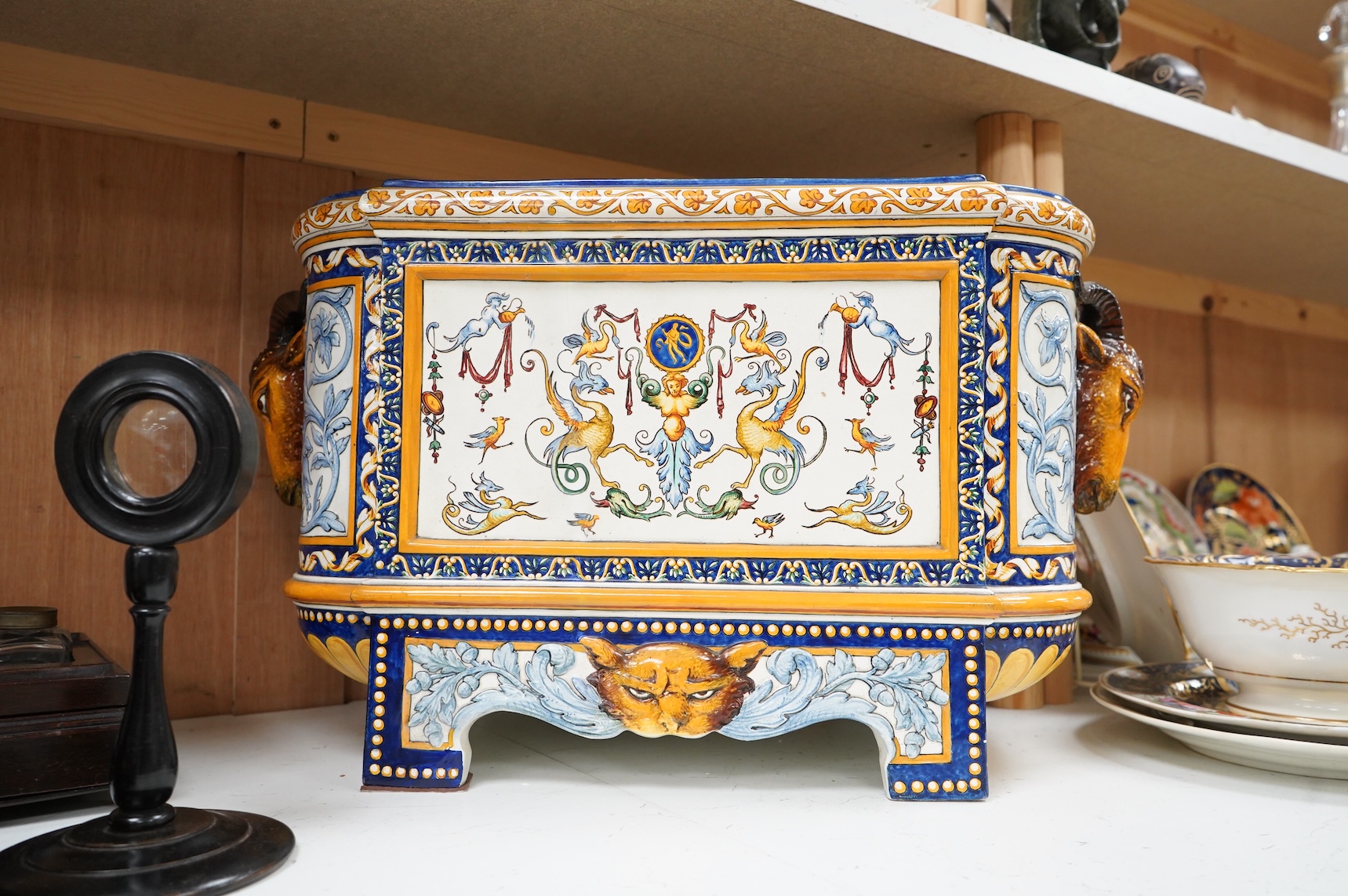 A large 19th century French faience wine cooler or planter with ram’s head handles, 60cm wide